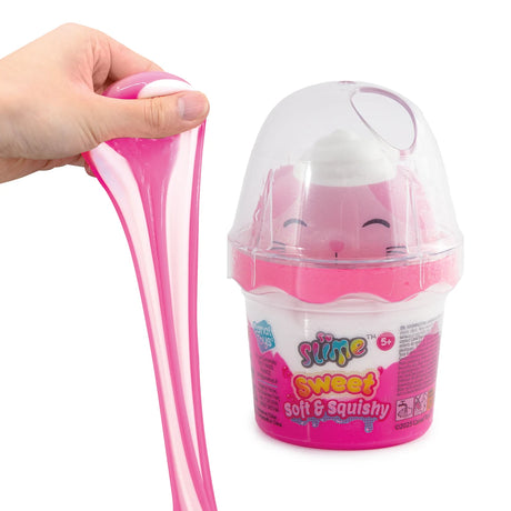 So Slime Sweet Soft & Squishy pink and white slime being stretched by hand beside a pink pot with a clear domed lid containing a smiling pink cat squishy figure.