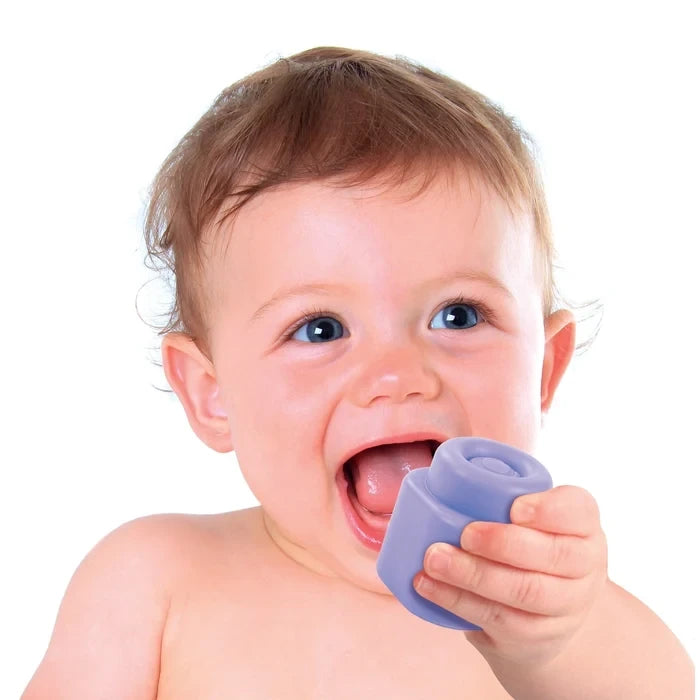 Close-up of a smiling baby holding a purple Soft Clemmy building block near their mouth against a white background.