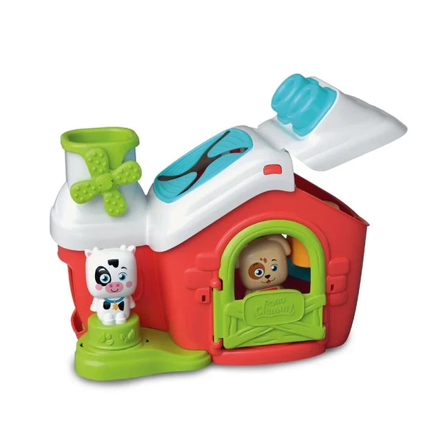 Soft Clemmy Sensory Farm with red barn, white roof lifted open, green windmill, blue textured roof panel, white cow figure beside the barn and brown dog peeking through the green door.