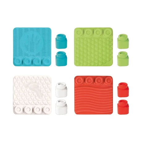 Soft Clemmy Sensory Path contents arranged in four groups, showing turquoise, green, white and red textured tiles with raised hand, footprint, circular and wavy patterns, and eight matching soft blocks.