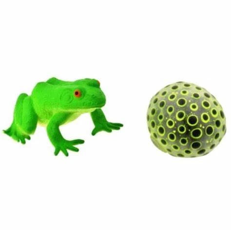 Green frog toy beside a black and yellow hole pattern squish ball