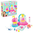 Squish Squish DIY Squishy Factory displayed with its retail box, pink and turquoise mixing machine, bunny and paw moulds, pink and blue squishies, coloured dyes, glitter, star confetti and pom poms.