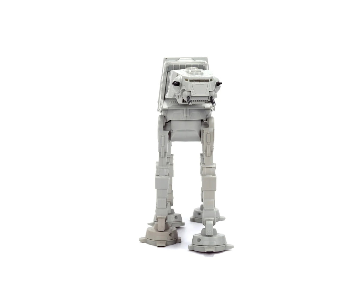 Front view of the grey Star Wars RC Walking AT-AT showing its armoured head, black laser cannons and four mechanical legs.