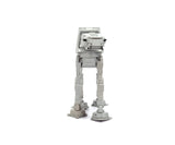 Front view of the grey Star Wars RC Walking AT-AT showing its armoured head, black laser cannons and four mechanical legs.