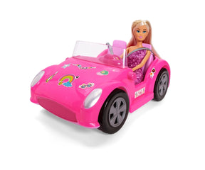 Steffi Love doll wearing a purple floral dress seated in a bright pink convertible with grey wheels, transparent windscreen and colourful stickers on the bonnet.