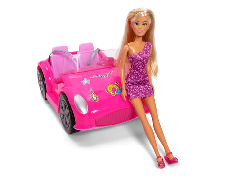 Steffi Love blonde doll in a purple one shoulder floral dress and pink sandals sitting on the bonnet of her bright pink convertible car.