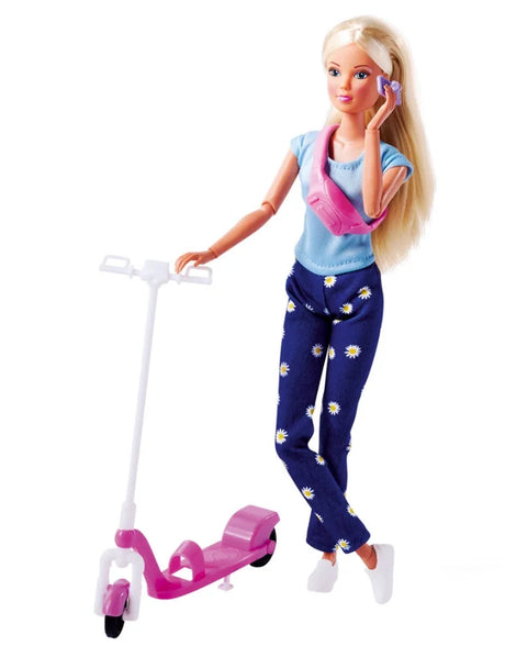 Steffi Love doll posed beside her pink scooter on a white background