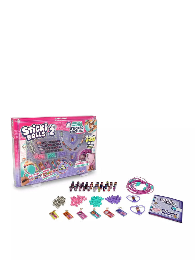 Sticki Rolls Series 2 Sticki Station shown with box and full contents including 32 sticker rolls, coloured beads, 6 charm tags, elastic cords, heart-shaped necklace pendants and Series 2 collector's manual