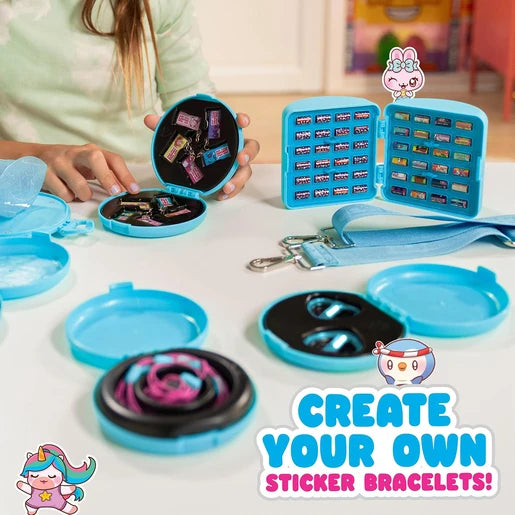 Child arranging Sticki Rolls inside open turquoise storage compartments, with bracelet cords, beads, sticker rolls and the blue handbag strap on a table.