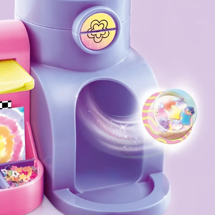 Purple Style 4 Ever Scrapbooking Studio Pro workstation showing a decorated transparent bear shaped 3D sticker beside the circular opening, with colourful miniature decorations in the storage compartments.