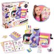 Style 4 Ever Scrapbooking Studio Pro retail box displayed beside the assembled purple and pink workstation, an open decorated journal, colourful paper sheets, decorative stickers and a girl holding a finished scrapbook.