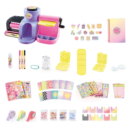 Style 4 Ever Scrapbooking Studio Pro contents arranged on a white background, including the purple and pink workstation, spiral notebook, three markers, cutting and embossing plates, decorative tapes, patterned paper, sticker sheets and packets of craft decorations.