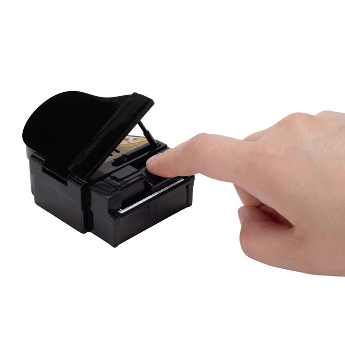Hand pressing a key on the piano accessory from the Super Mario Galaxy Movie Bowser Castle Playset