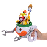 Hand holding the Super Mario Galaxy Movie Bowser Jr. Clown Car with Bowser Jr. holding the large orange brush