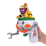 Hand holding the Super Mario Galaxy Movie Bowser Jr. Clown Car with its grey arms extended