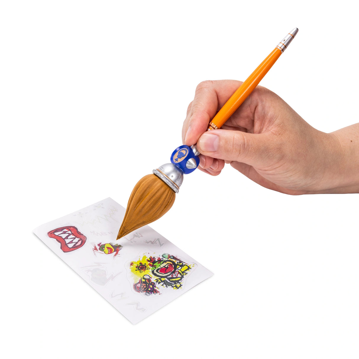 Hand using the large orange brush on a sticker sheet with several colourful designs visible