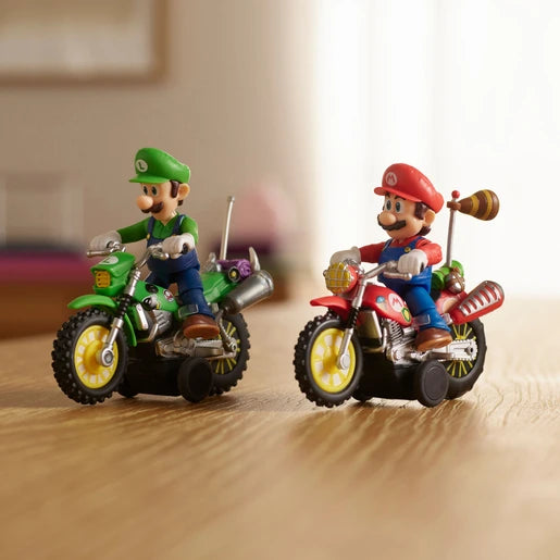 Luigi riding a green motorcycle alongside Mario on a red motorcycle, both with yellow wheels, photographed on a wooden tabletop.