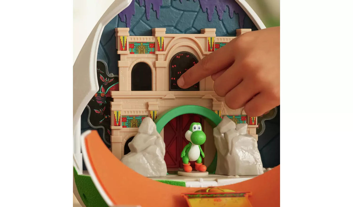 Close-up of the Super Mario Galaxy Movie Yoshi Egg Playset showing a hand pressing a dark arched panel on the castle wall, with Yoshi standing beneath the green archway.