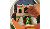 Close-up of the Super Mario Galaxy Movie Yoshi Egg Playset showing a hand pressing a dark arched panel on the castle wall, with Yoshi standing beneath the green archway.