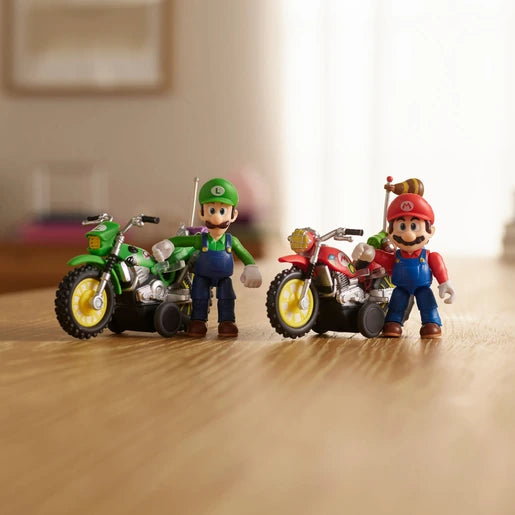 Luigi and Mario figures standing beside their green and red motorcycles on a wooden floor, with yellow wheels and black pull back mechanisms visible.