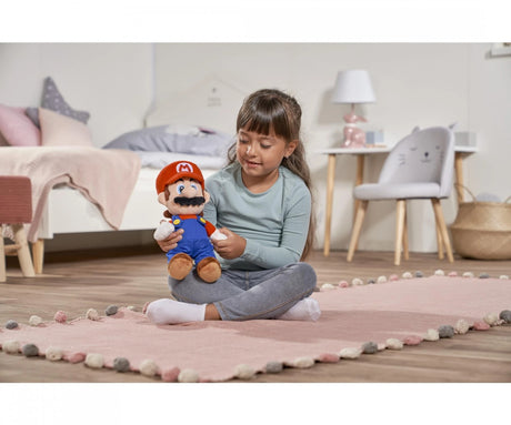 Child holding Super Mario Mario plush toy on bedroom rug
