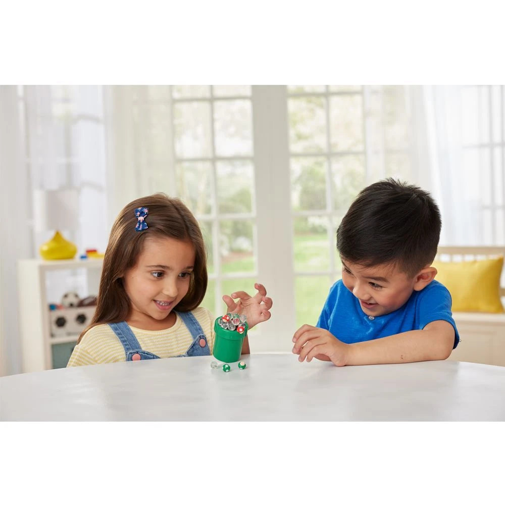 Two children playing with the Super Mario Mushroom Mania Balancing Game on a table with the green pipe base and mushroom pieces