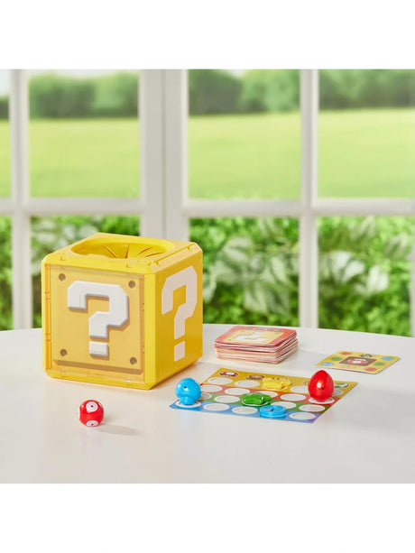 Super Mario Question Block Party Game set on a table with the Question Block, stacked cards, a game board and item pieces laid out for play