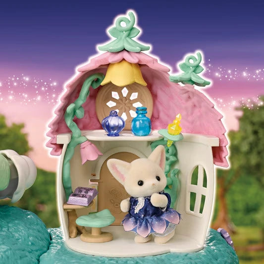 Close-up of the flower house interior beneath a pink petal roof, with a Fennec Fox baby in a blue flower dress, green stool, book and miniature magic vials.