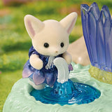 Close-up of a Fennec Fox baby wearing a dark blue and purple flower petal dress beside a white water spout and bright blue fountain basin, with purple crystals on the right.