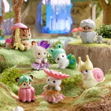 Sylvanian baby figures in woodland fairy costumes shown in a mossy woodland scene