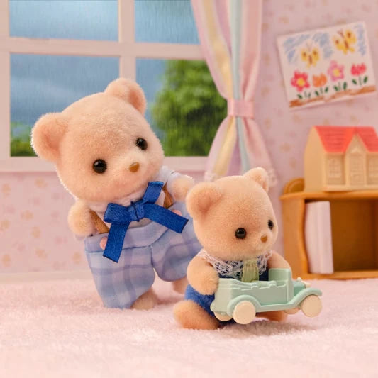 Close-up of two Biscuit Bear figures with a small toy car