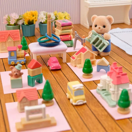 Biscuit Bear figure shown beside a tabletop scene with colourful blocks, trees and buildings