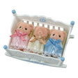 Empty white Sylvanian Families rocking cradle with blue finials, floral decorations and a yellow mattress with three raised sleeping sections.