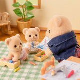 Biscuit Bear figures shown at a green check table with drawing paper and small blocks