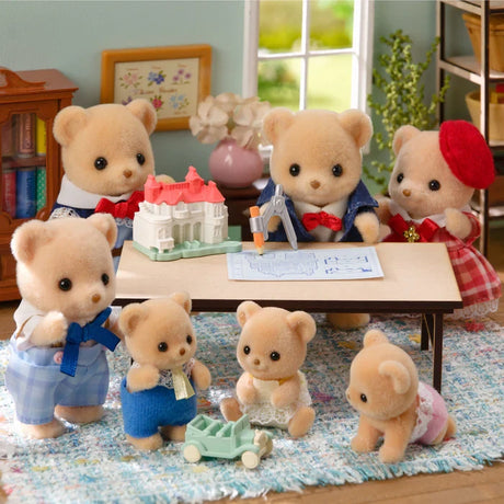 Biscuit Bear figures shown around a table with a model house and drawing paper