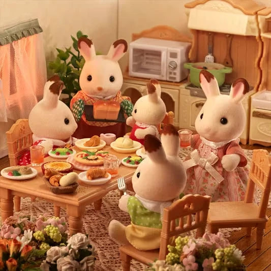 Chocolate Rabbit figures shown around a dining table with food and cups