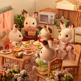 Chocolate Rabbit figures shown around a dining table with food and cups