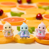 Three small bird figures shown close up on orange ride seats