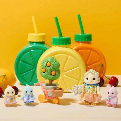Citrus Bird figures shown with drink cups, fruit tree in a flowerpot and cart