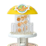 Close-up of the clear juice tower with orange pieces under a yellow roof