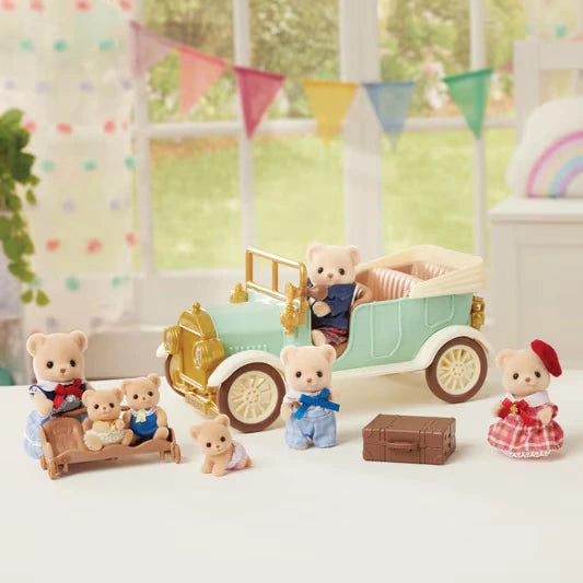 Sylvanian Families Classic Family Car with animal passengers, figures standing beside the vehicle, a pram and brown suitcase.