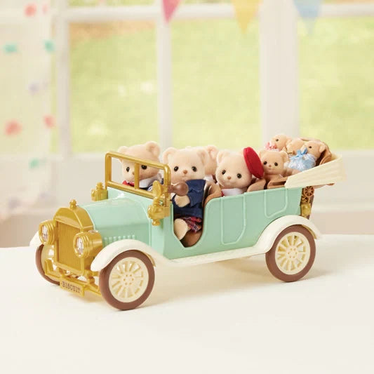 Front three-quarter view of the Sylvanian Families Classic Family Car filled with animal figures in the front and rear seats.
