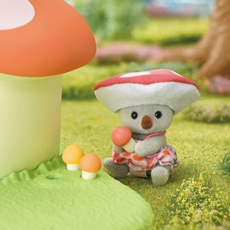 Sylvanian Families Fairy Mushroom House with miniature characters arranged beside the mushroom shaped building in a garden scene.