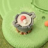 Small red capped mushroom character from the Sylvanian Families Fairy Mushroom House playset pictured among garden foliage.