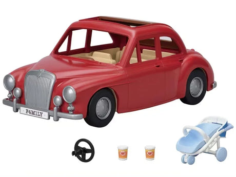Red Family Cruising Car with baby buggy, cups, and steering wheel laid out in front in Ireland.