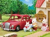 Chocolate Rabbit family beside Family Cruising Car with baby in buggy outside house scene in Ireland.
