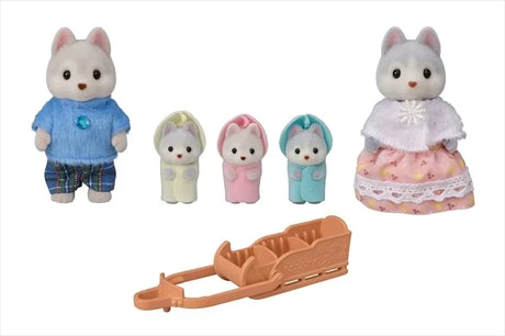 Husky Family figures with father, mother, triplets in coloured outfits, and sleigh accessory displayed together in Ireland.