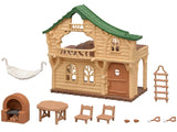 Sylvanian Families Lakeside Lodge cabin and accessories displayed separately on a white background, including the hammock, rope ladder, brick stove, table, chairs and cups.