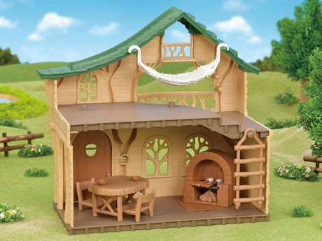 Open interior of the Sylvanian Families Lakeside Lodge showing the dining furniture, brick stove, rope ladder and hammock beneath the roof.