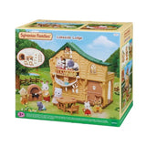 Sylvanian Families Lakeside Lodge 5451 retail packaging featuring the green roofed log cabin, animal figures, hammock and miniature furniture.